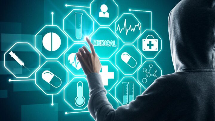 Hooded man touching medical icons appearing as a 3D interface display