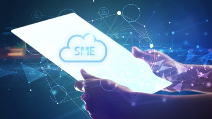 Business professional holding a digital tablet displaying a cloud with SME branding, representing how to secure Microsoft 365 for small and medium businesses through cloud security and cybersecurity best practices.
